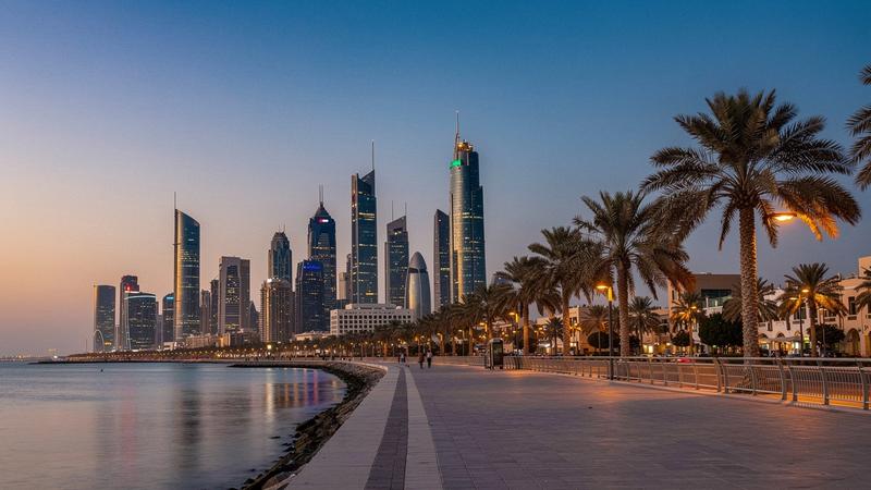 Abu Dhabi skyline above the Corniche promenade at dusk